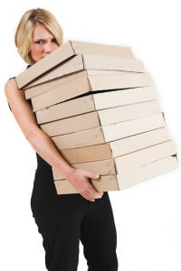 Picture od a woman carrying a stack of boxes